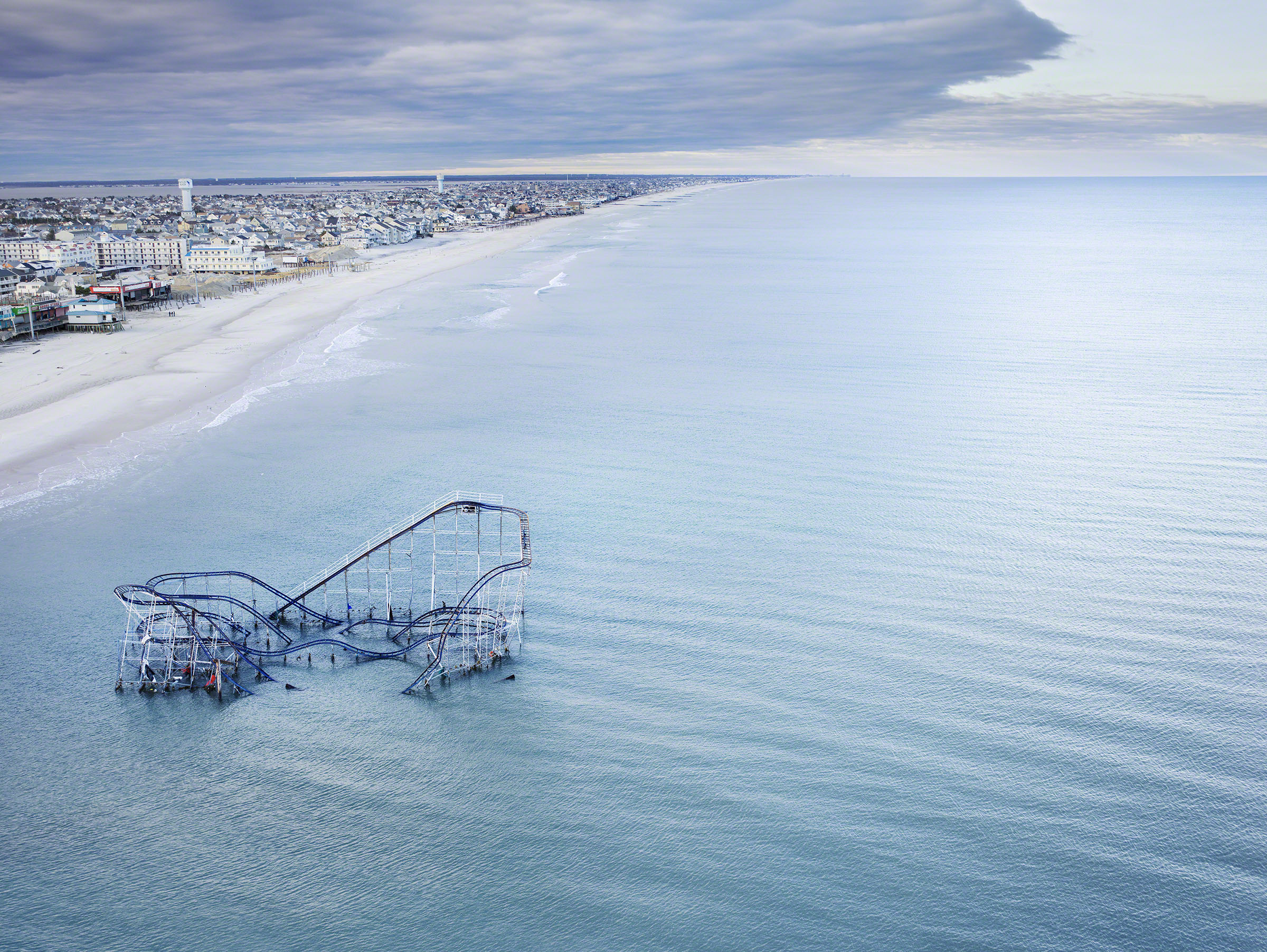 The roller coaster from the boardwalk in Seaside Heights, New Jersey, USA, partially submerged in the ocean after Hurricane Sandy. Photo: Stephen Wilkes courtesy of Peter Fetterman Gallery  