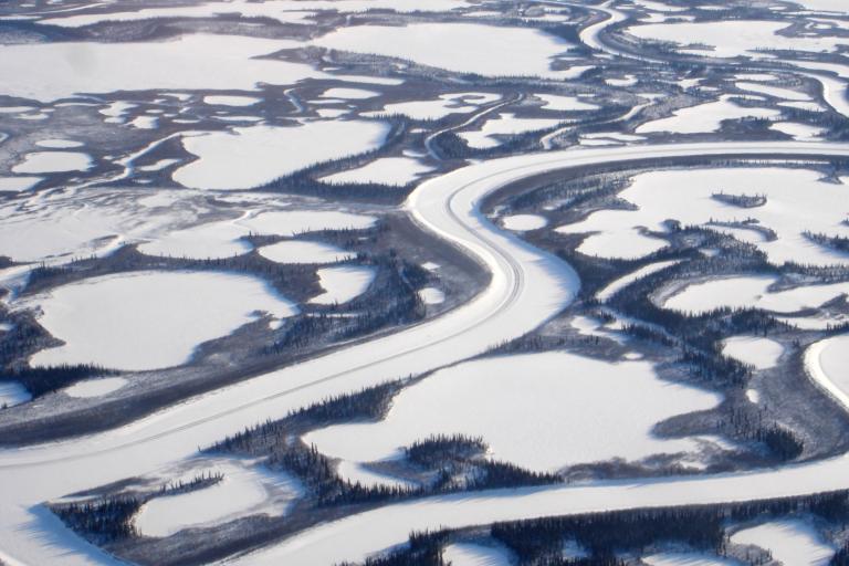 An aerial view of a river in the snow.