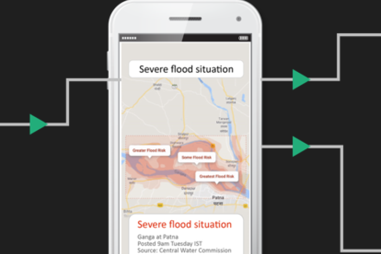 A smartphone with a map showing a flood alert.