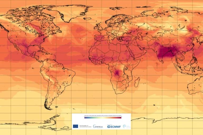 A heat map of the world displaying temperature anomalies, showing higher temperatures in dark red and lower temperatures in light orange.
