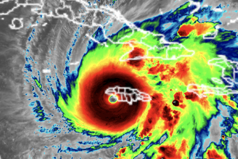 Infrared satellite image showing a large hurricane with a defined eye over the Caribbean, affecting islands including Haiti, Jamaica, and Cuba.