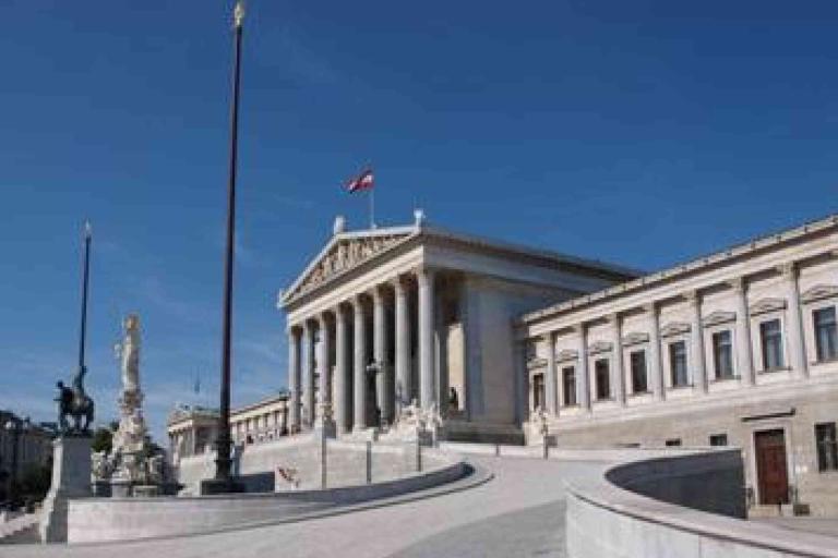 The image shows the Austrian Parliament building in Vienna, featuring neoclassical columns, statues, and the Austrian flag atop the main structure.