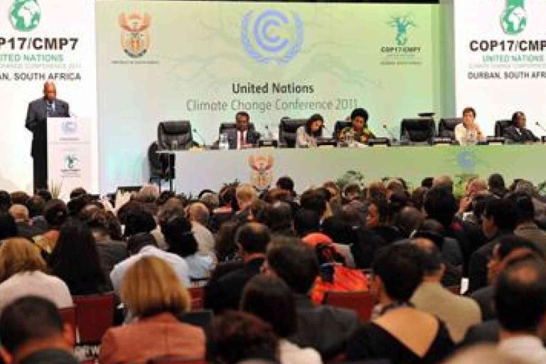 A large audience listens to speakers and panelists at the United Nations Climate Change Conference 2011 (COP17/CMP7) in Durban, South Africa.