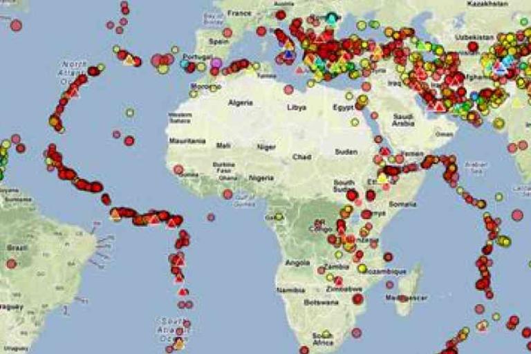 A world map displays clusters of colored dots marking earthquake locations and seismic activity zones across continents and oceans.