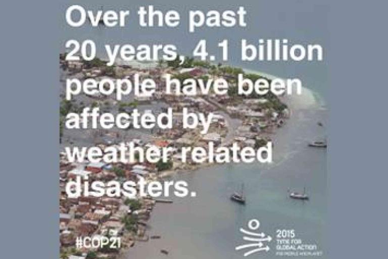 Aerial view of a coastal town with text stating that 4.1 billion people have been affected by weather-related disasters over the past 20 years.