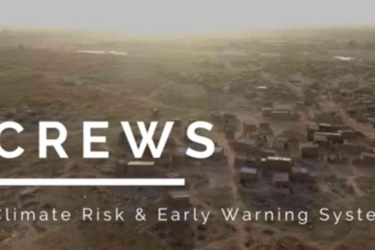 Aerial view of a rural landscape with scattered buildings. Text overlay reads: "CREWS Climate Risk & Early Warning Systems.