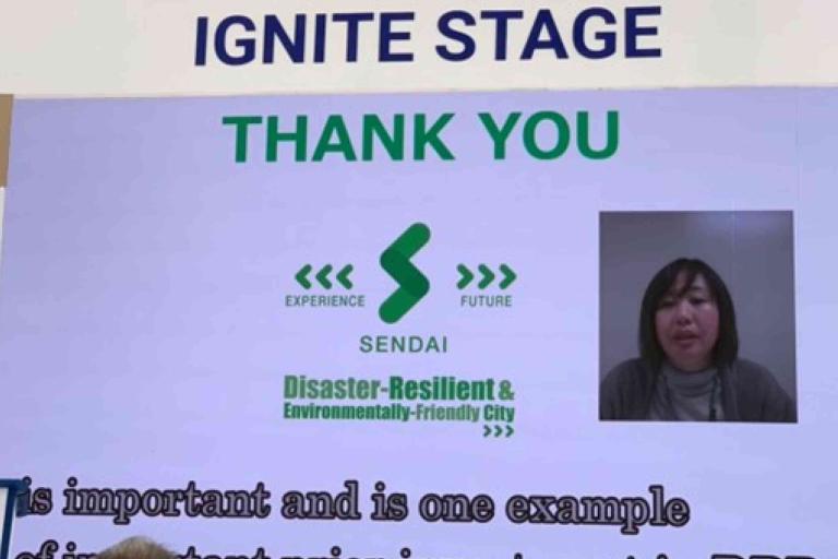 A presentation slide for Sendai as a disaster-resilient, environmentally friendly city reads "THANK YOU" and features a video call speaker and logos on the Ignite Stage.