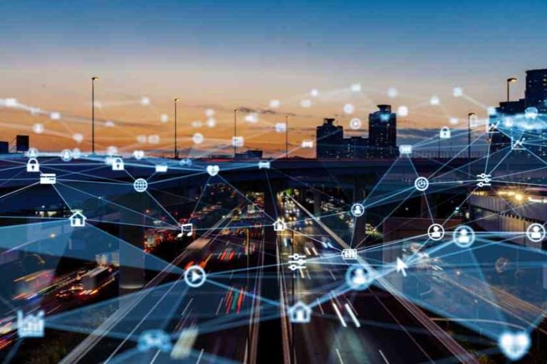 City highway at dusk with digital network icons and lines overlaid, representing smart technology, connectivity, and Internet of Things (IoT) integration in urban infrastructure.