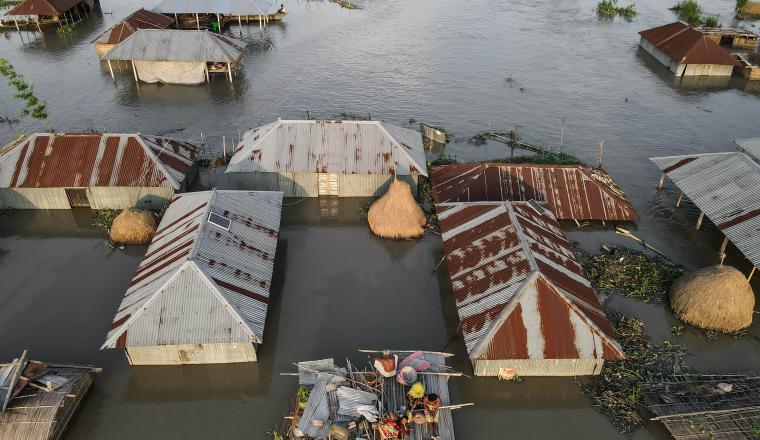 An aerial view of flooded huts in cambodia.