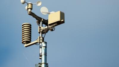 A weather station on top of a pole.