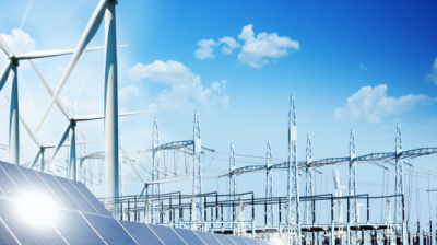 Image shows solar panels, wind mills and a power grid against a blu sky with small clouds