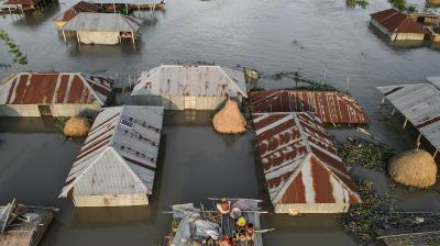 An aerial view of flooded huts in cambodia.