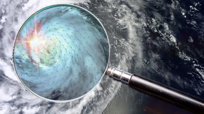 A magnifying glass with a hurricane in the background.