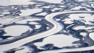 An aerial view of a river in the snow.