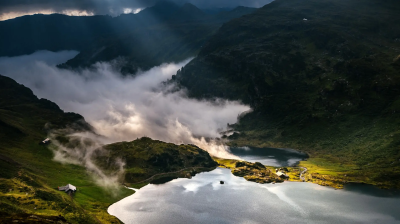 A lake in the mountains under a cloudy sky.