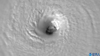 Satellite image of a hurricane's eye viewed from above, showing swirling cloud patterns.