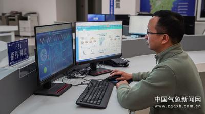 A person in an office analyzes data on two computer monitors displaying graphs and charts.