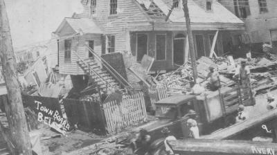 Broken and damaged piled-up objects and house