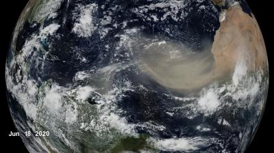 Satellite view of Earth showing a large Saharan dust plume moving westward from Africa over the Atlantic Ocean toward the Americas, dated June 18, 2020.