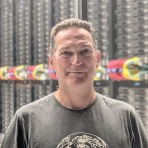 A man standing in front of a server room.