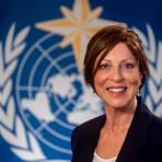 Roberta Boscolo standing in front of a united nations flag.