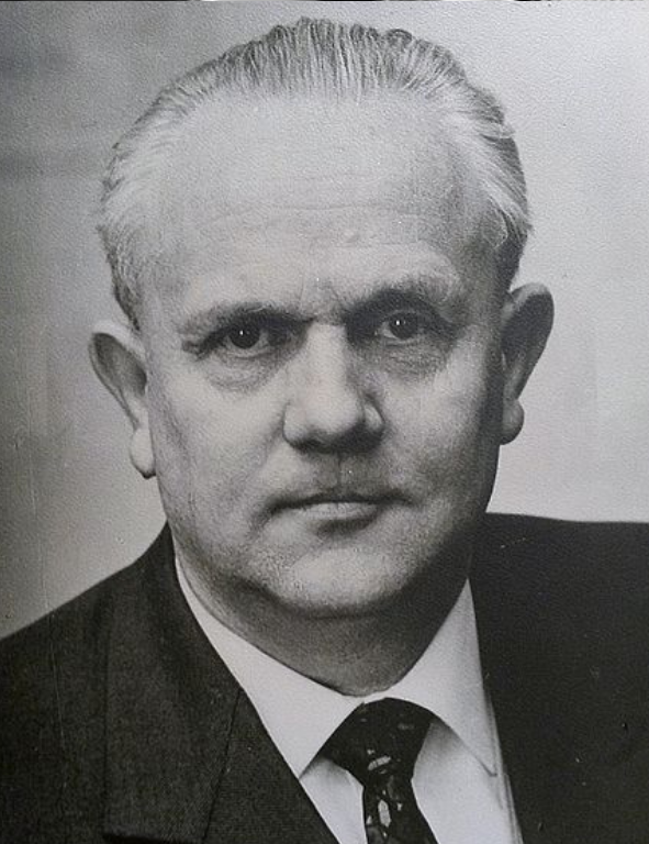 A black and white photo of a man in a suit and tie.