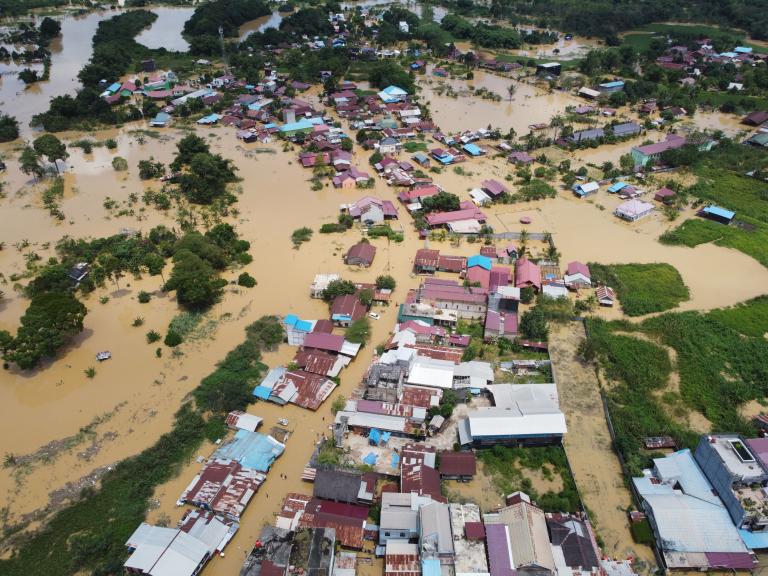An aerial view of a flooded village.