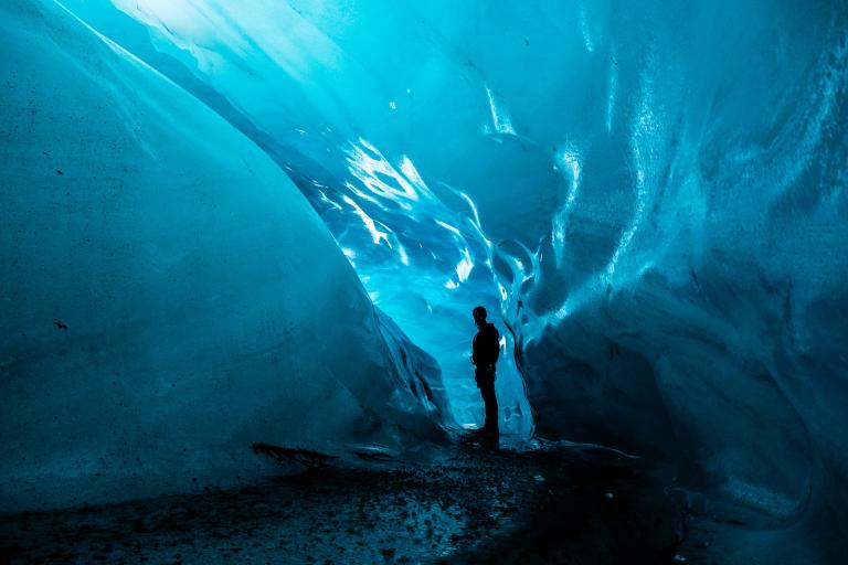 A person standing in the middle of an ice cave.