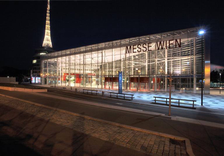 A building with the words messe wien at night.