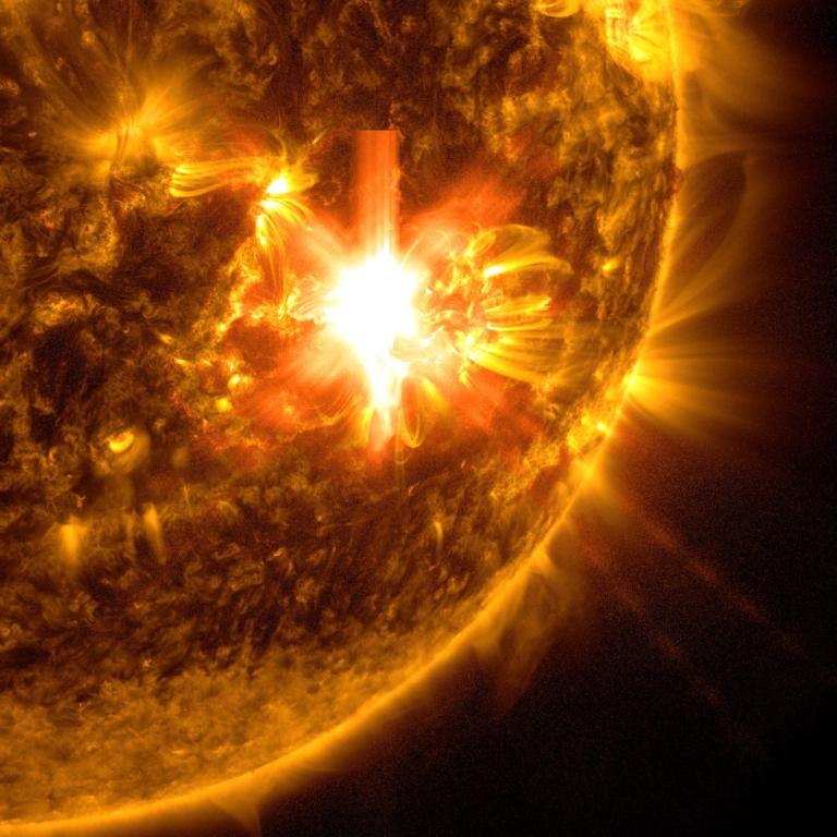 A close-up image of a bright solar flare on the sun's surface, highlighting intense light emissions and magnetic activity.