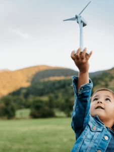 A child holding a small wind turbine