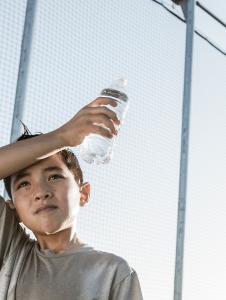 Boy wipes sweaty forehead