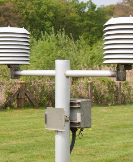 A weather station in a field.