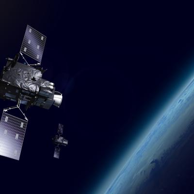 Two satellites orbit Earth in space, with part of the planet visible in the background.