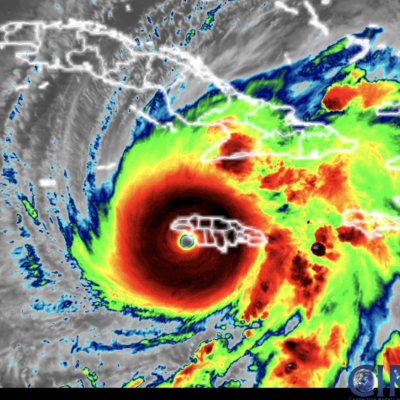 Infrared satellite image showing a large hurricane with a defined eye over the Caribbean, affecting islands including Haiti, Jamaica, and Cuba.