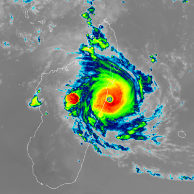 Infrared satellite image showing a strong cyclone with a defined eye making landfall on a coastal region, with intense rain bands surrounding the center.